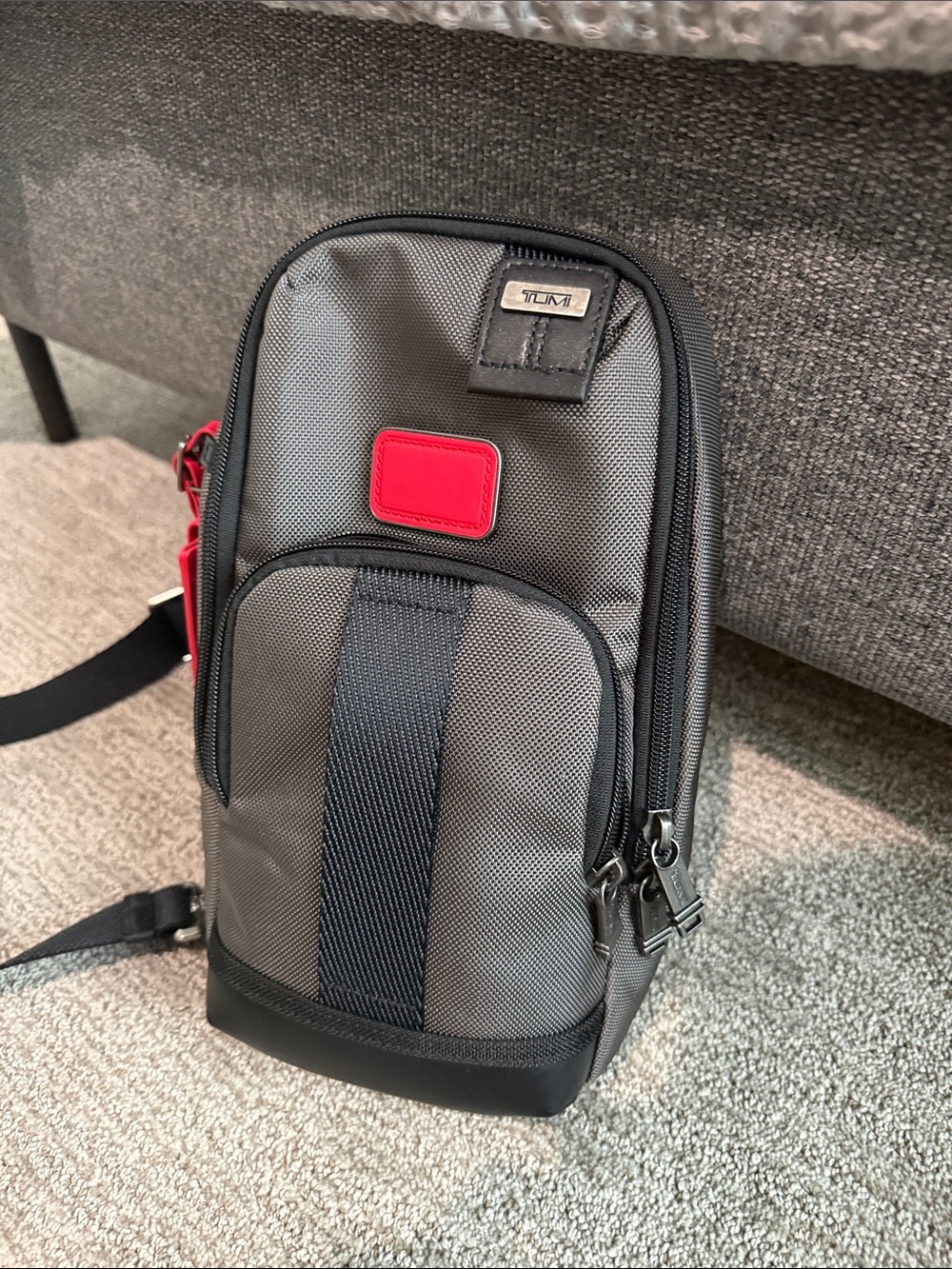 Tumi Gray Sling Bag with Red Accent- NEVER USED OR WORN. Tags removed, A gift - Picture 2 of 9